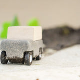 Close up of Plan Toys Wagon leaving a pile of mud