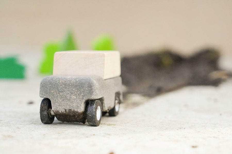 Close up of Plan Toys Wagon leaving a pile of mud