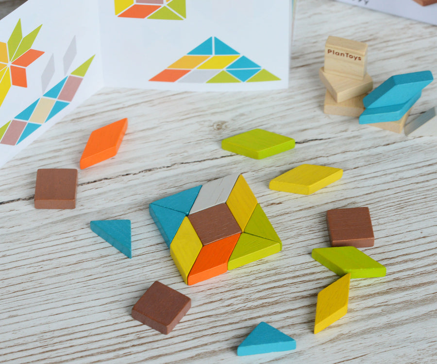 A square shape created using pieces from the PlanToys mini mosaic set, the ideas leaflet can be seen in the background. 