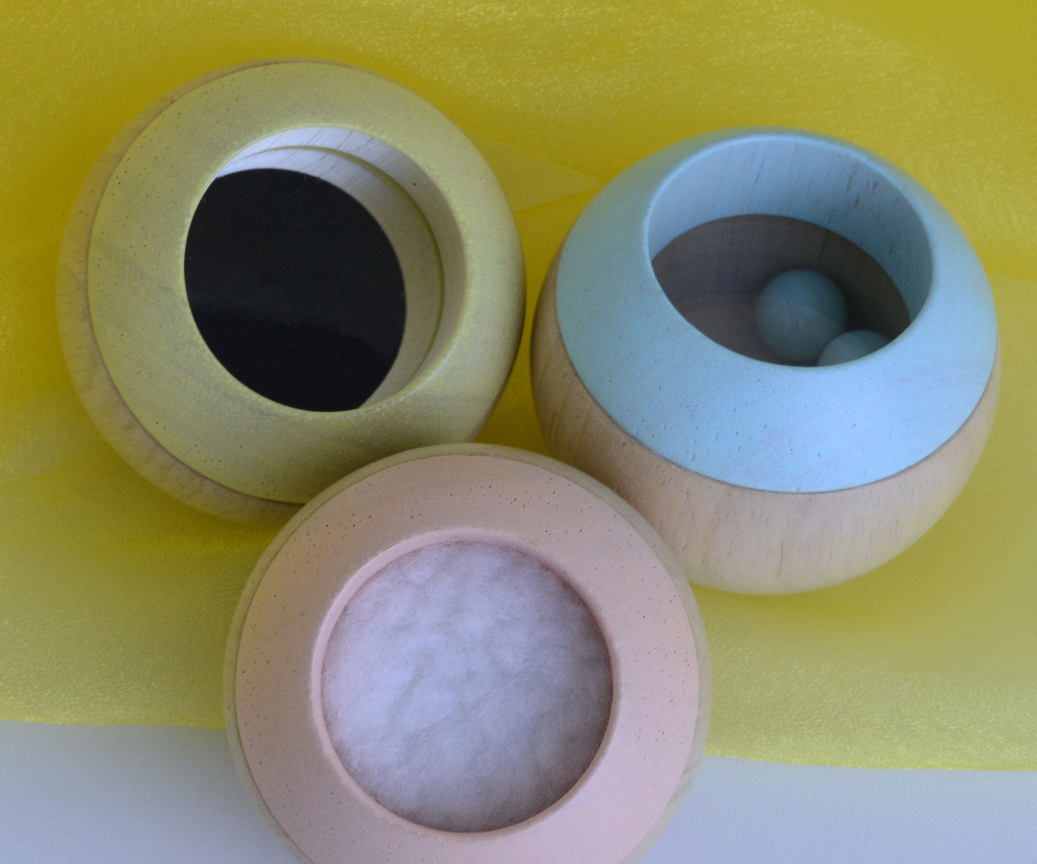 A top view of the Plan Toys Pastel Sensory Tumbling balls showing the different sensory elements. 