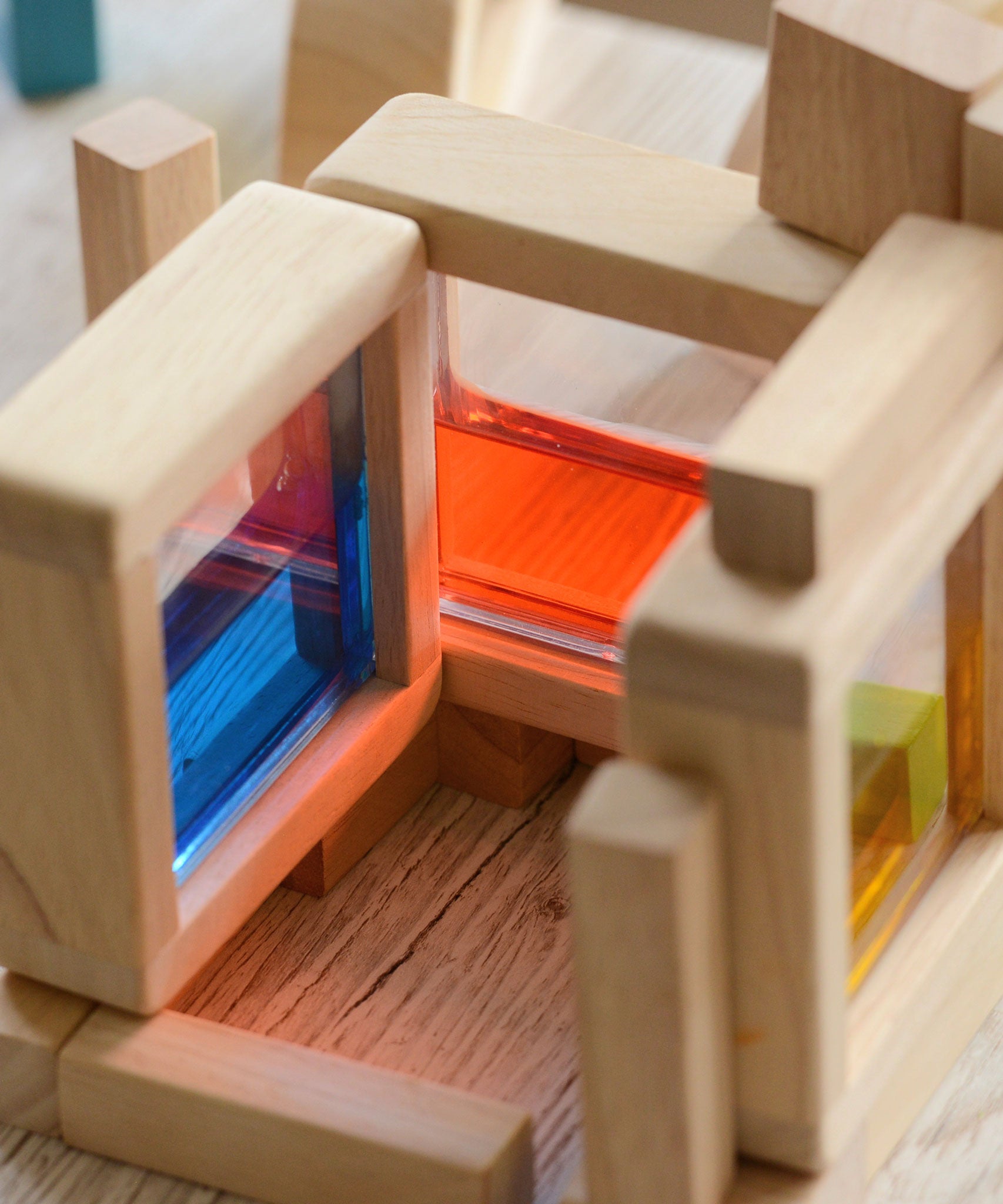 A close up of the Plan Toys Water Blocks showing the coloured liquid inside the block. 
