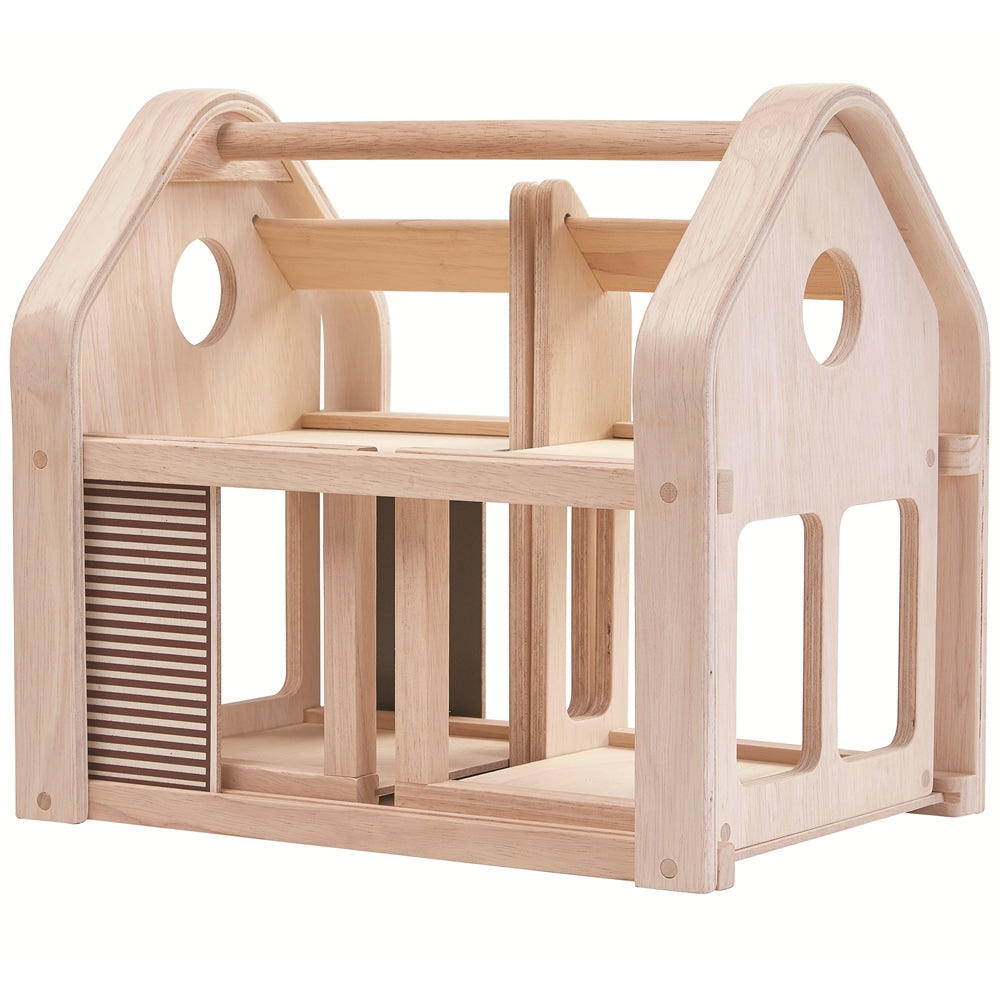 The PlanToys Slide N Go Dolls' House shown all slotted together on a plain background. 