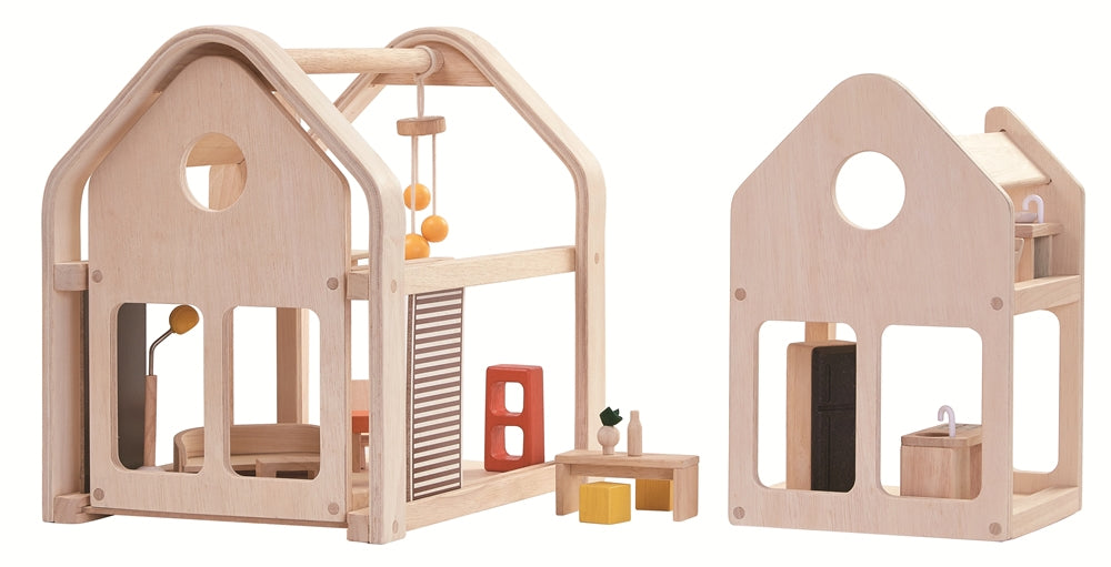 The PlanToys Slide N Go Dolls' House shown with the pieces separated on a plain background. 