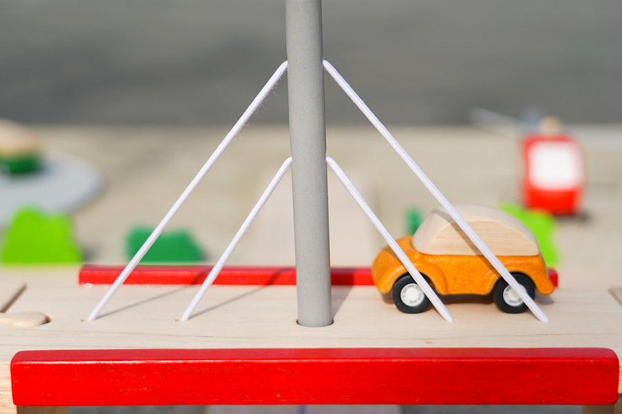 Close up of Plan Toys car on top of the Plan Toys Wooden Bridge