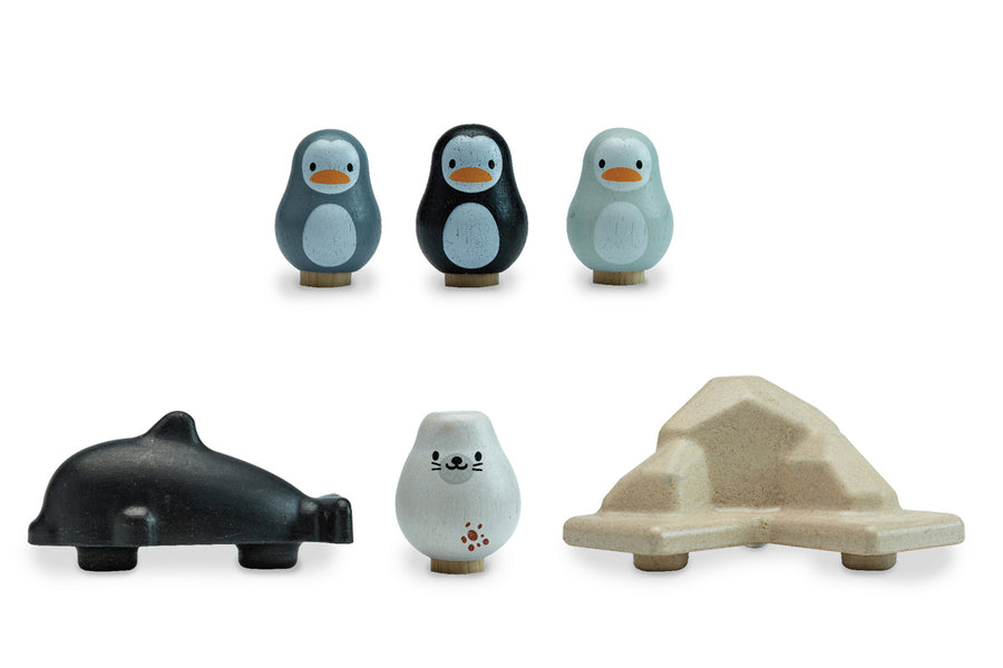 Pieces of the plan toys plastic free finding penguin family board game lined up on a white background