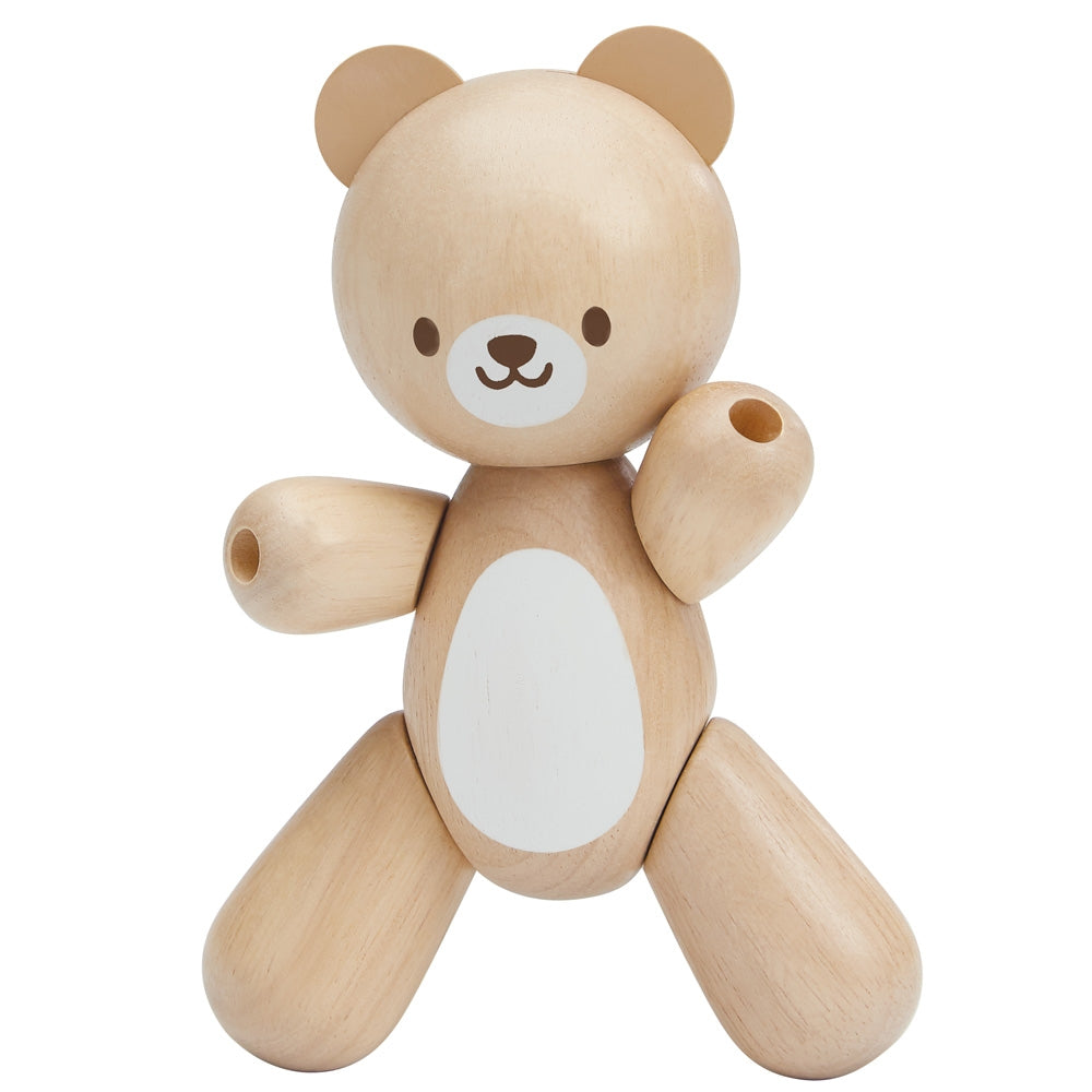 A PlanToys wooden toy bear on a plain background. 