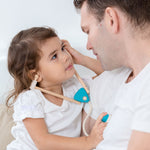 A child and adult playing with the PlanToys Doctor Set, the child has the stethoscope on and is listening to the adult's heart.