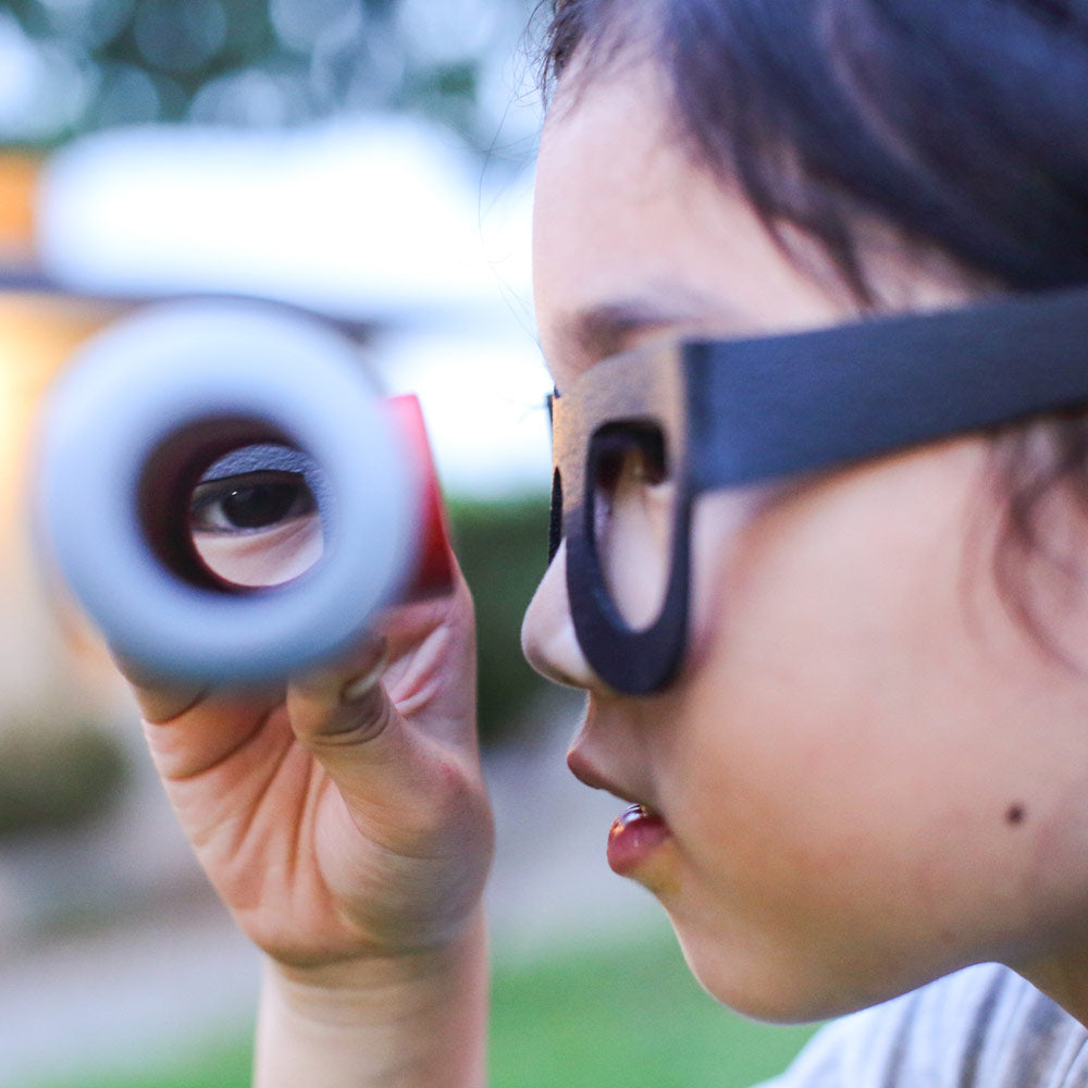 Child looking through the spyglass periscope in the PlanToys Detective Role Play Set