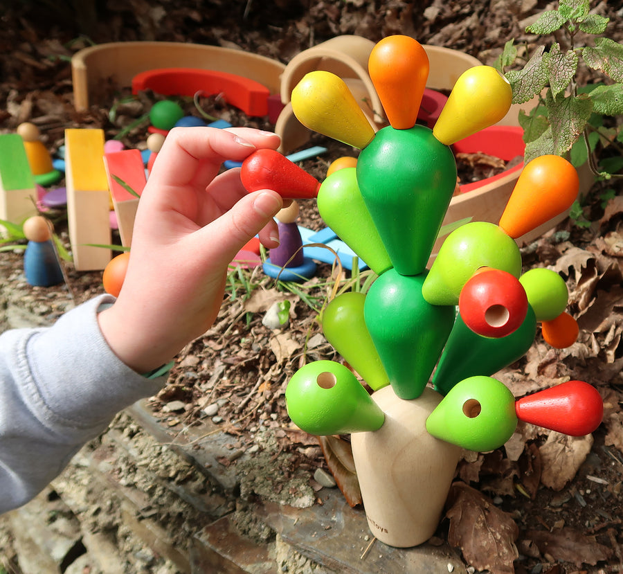 a wooden balance game for children and adults painted in green