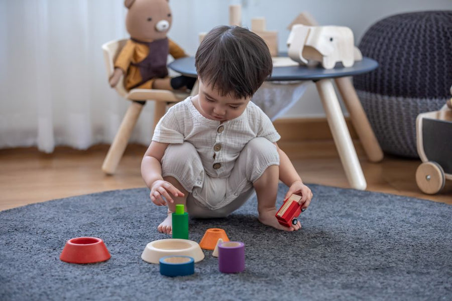 Child playing with the the Plan Toys Coloured Sorting Cones - a fun sorting game for toddlers