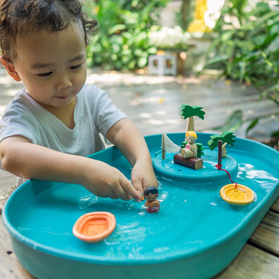 Close up of child playing with the Plan Toys Water Play Set - an exciting play tray inspiring creative water play and is a fabulous sensory toy for toddlers. 