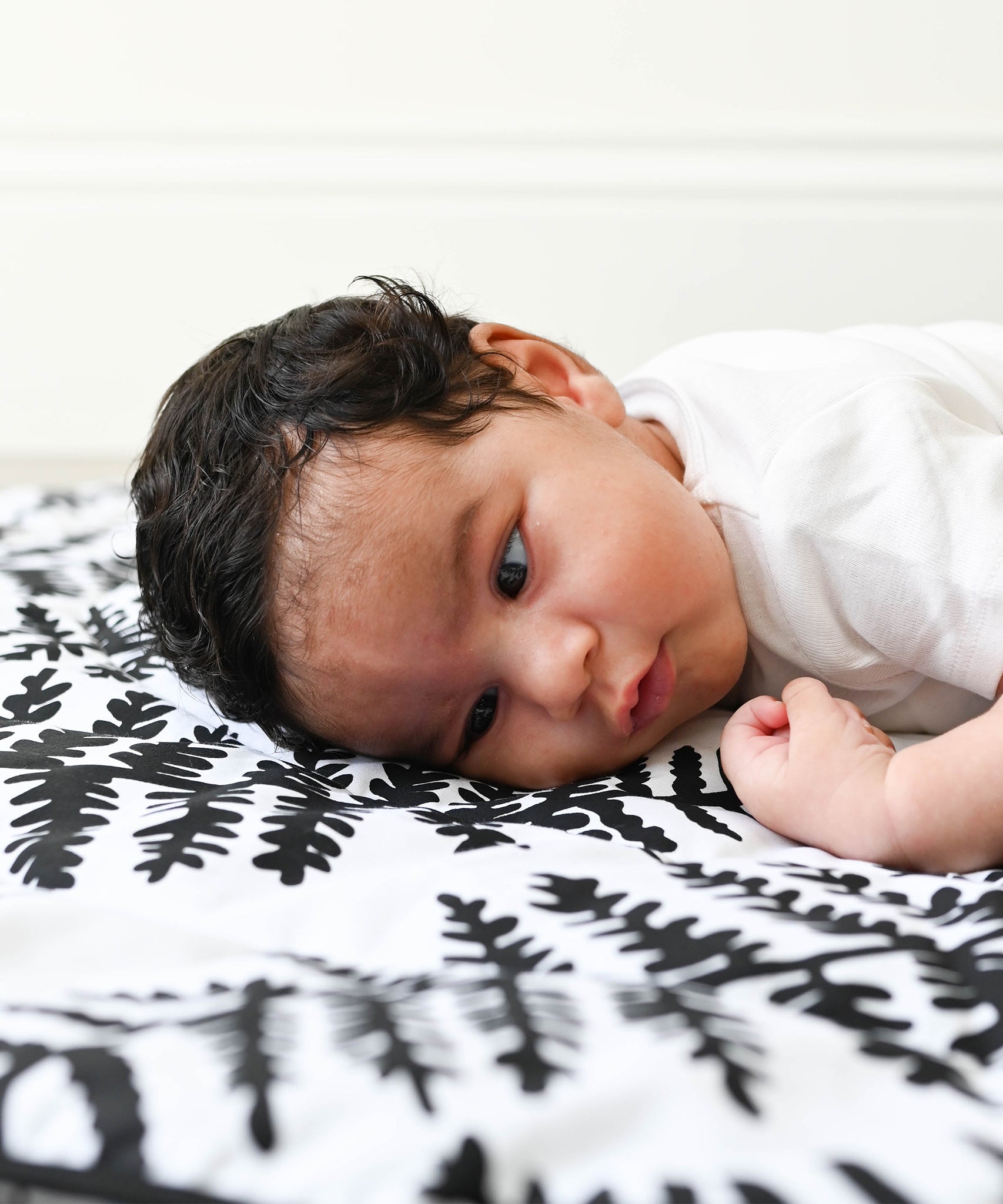 A closer look at the black and white Fern print on the Etta Loves Reversible Organic Cotton Baby Play Mat - Plant Print 