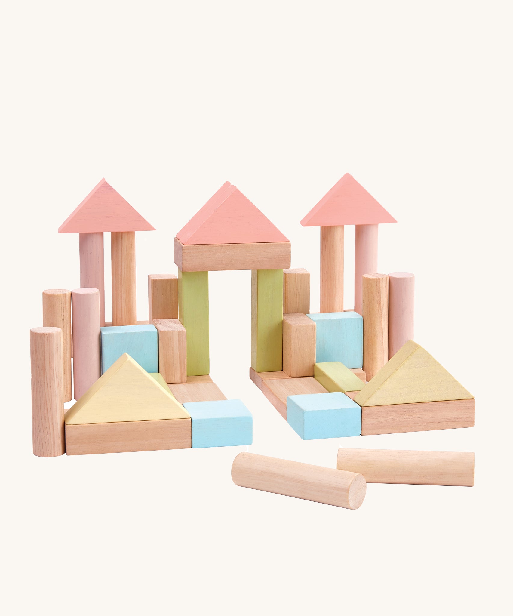 PlanToys 40 Pastel and Natural Blocks on a plain background. The blocks are shown out of the packaging built into a castle or palace like structure.