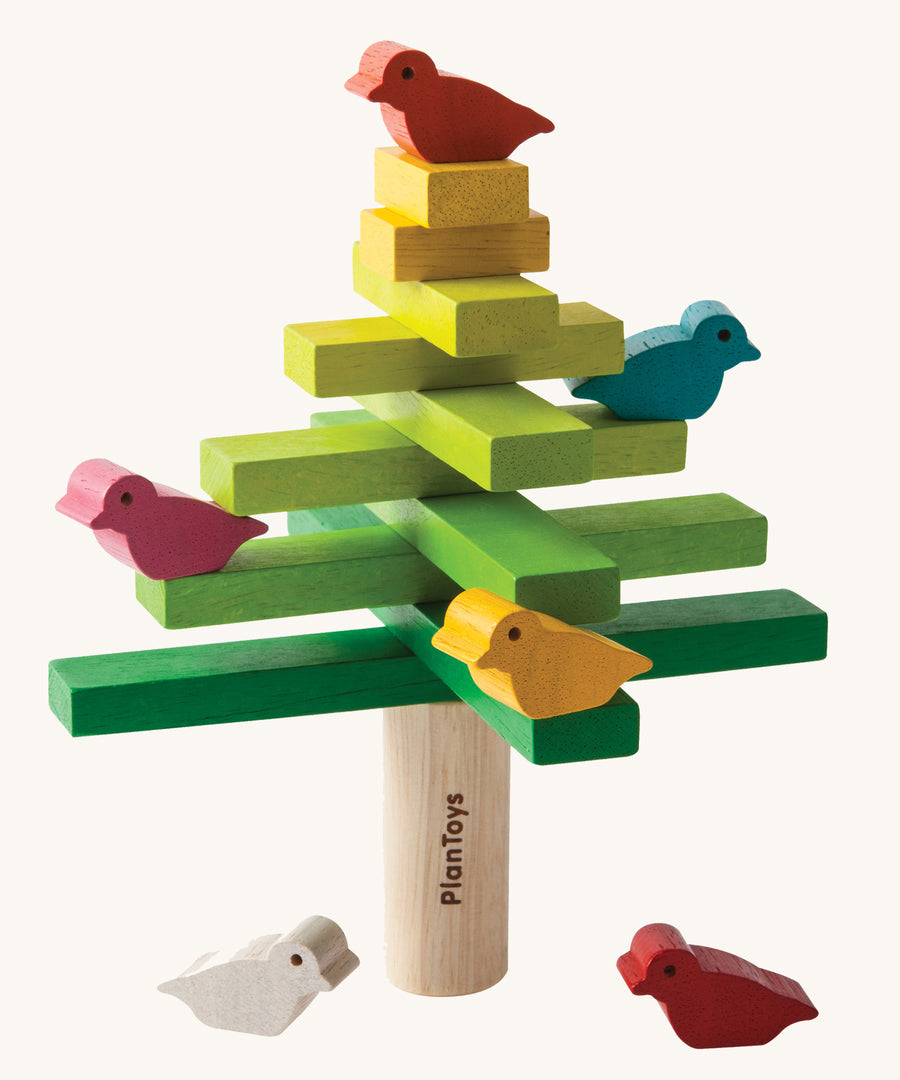 The PlanToys Balancing Tree on a plain background shown stacked up in a traditional tree style formation.
