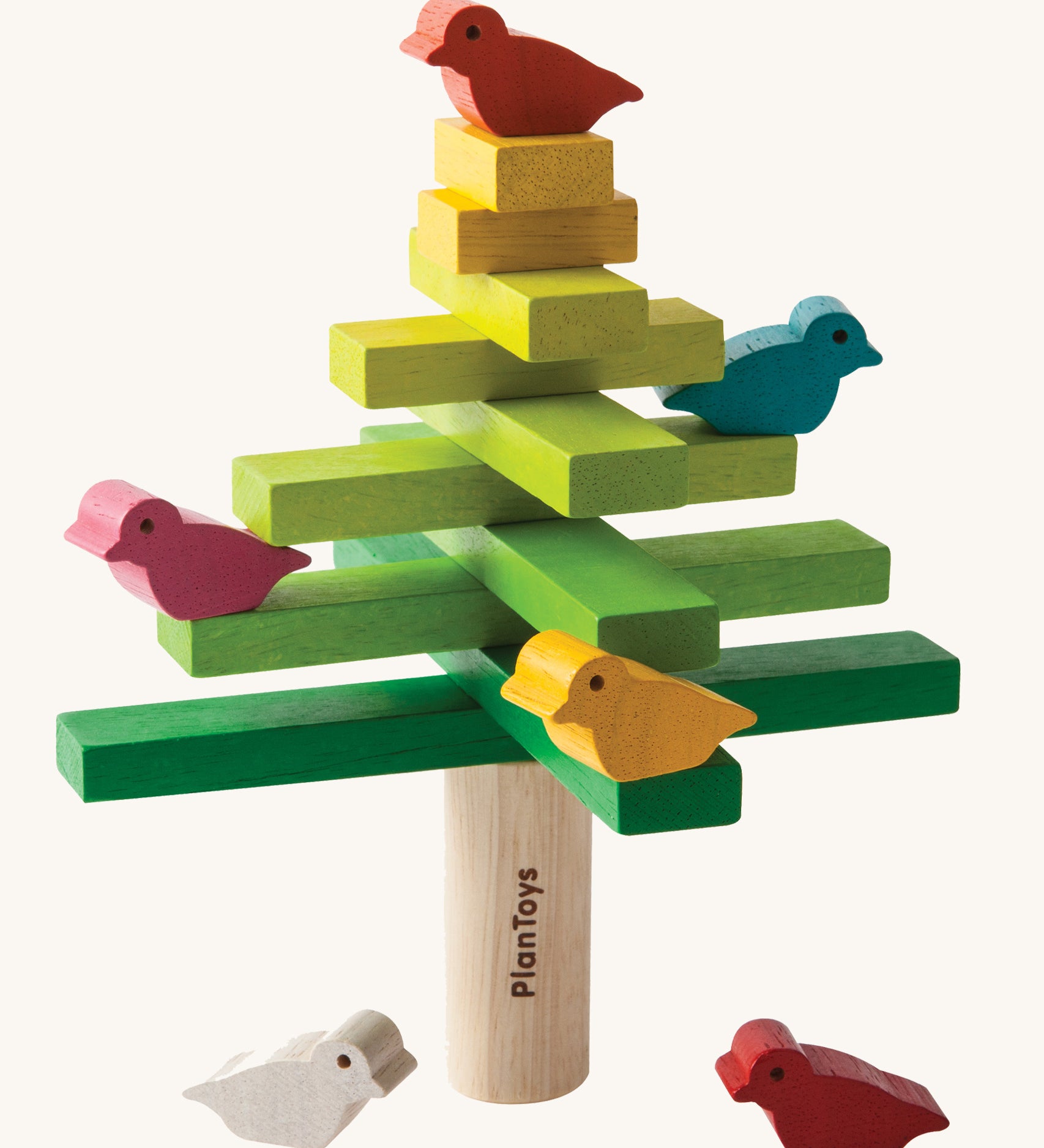 The PlanToys Balancing Tree on a plain background shown stacked up in a traditional tree style formation.
