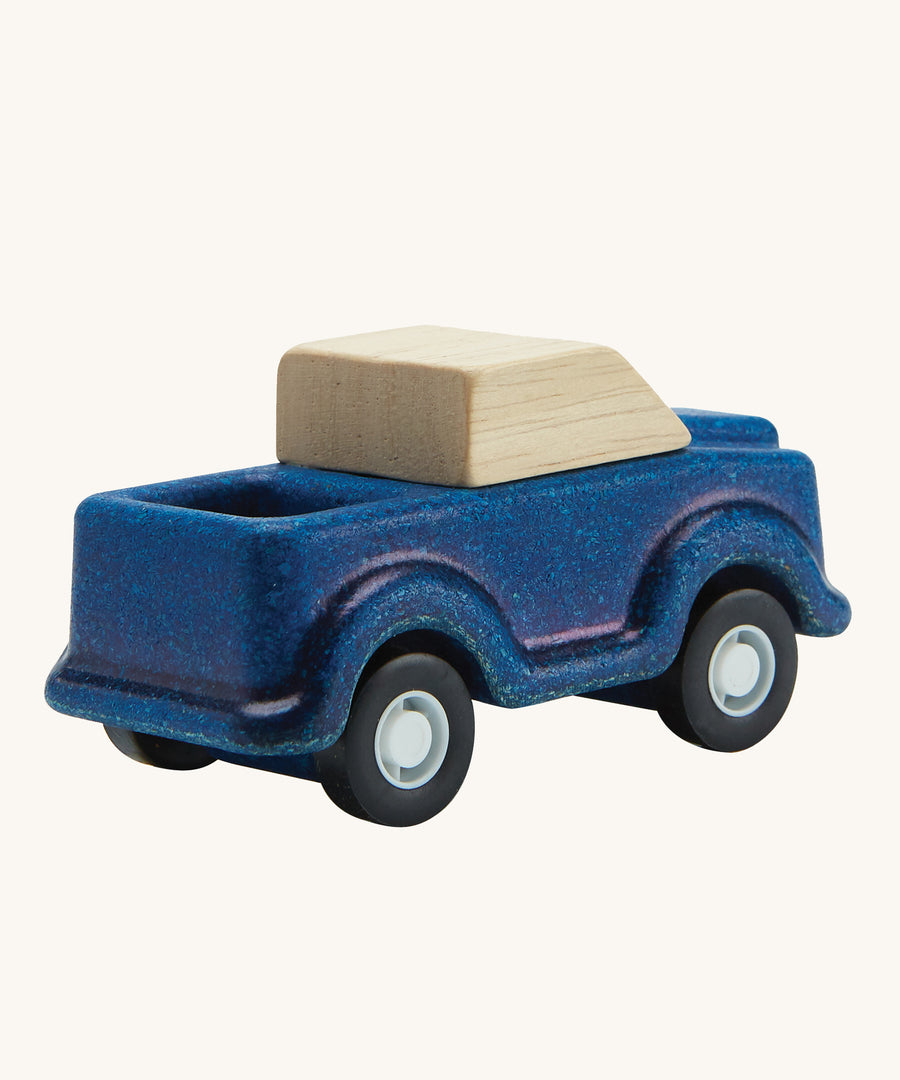 A view of the back of a PlanToys Blue Truck on a plain background. 
