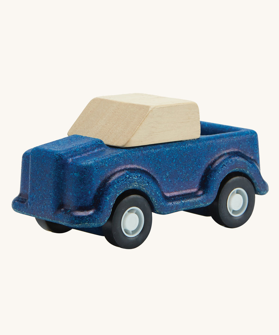 A PlanToys Blue Truck on a plain background. 
