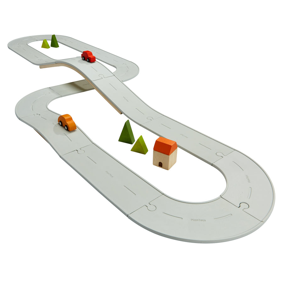 PlanToys eco-friendly childrens large rubber road and rail set laid out in town scene on a white background