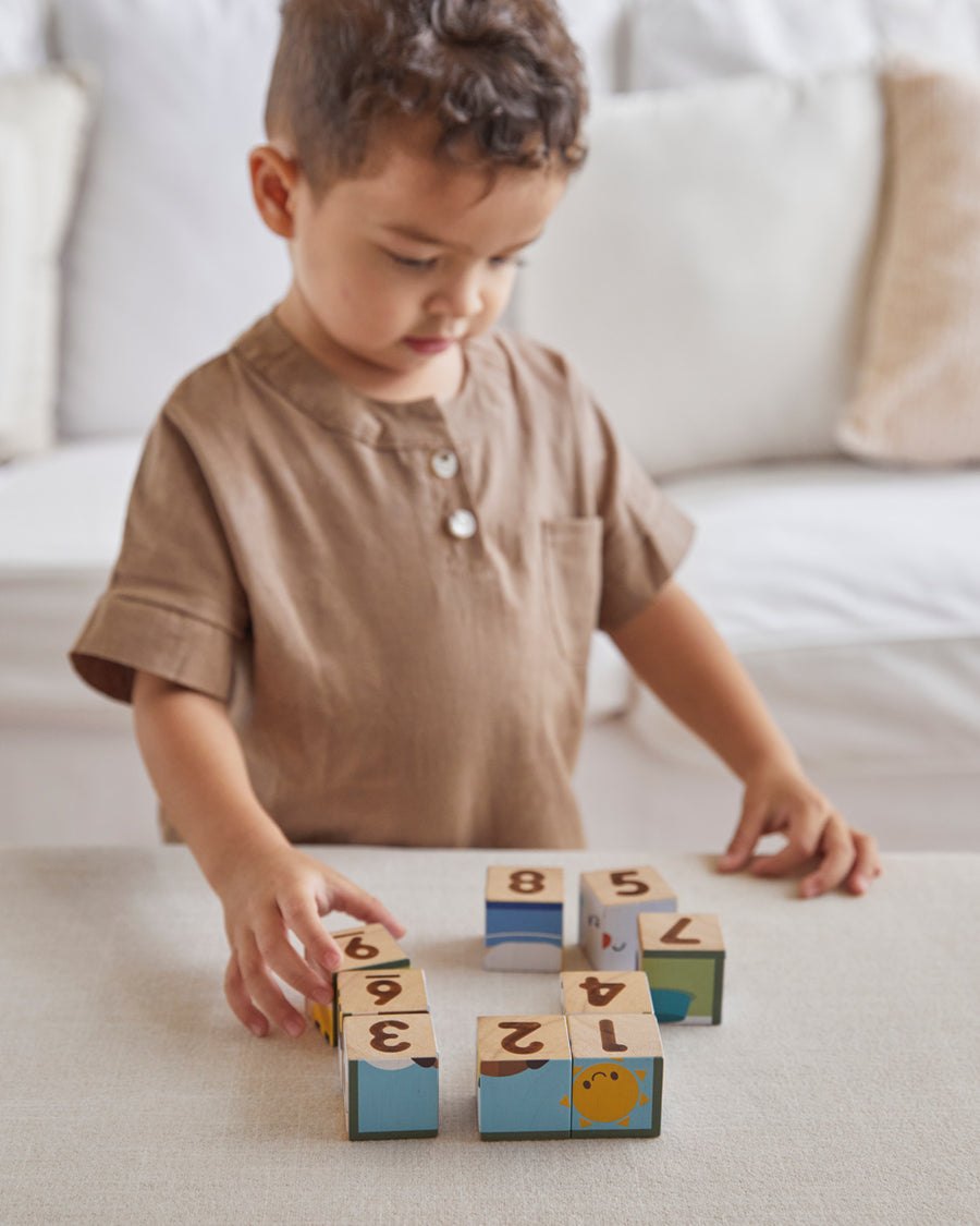 PlanToy plastic-free Waldorf blocks stacked in a pyramid showing counting dots from numbers 1-9 on the front