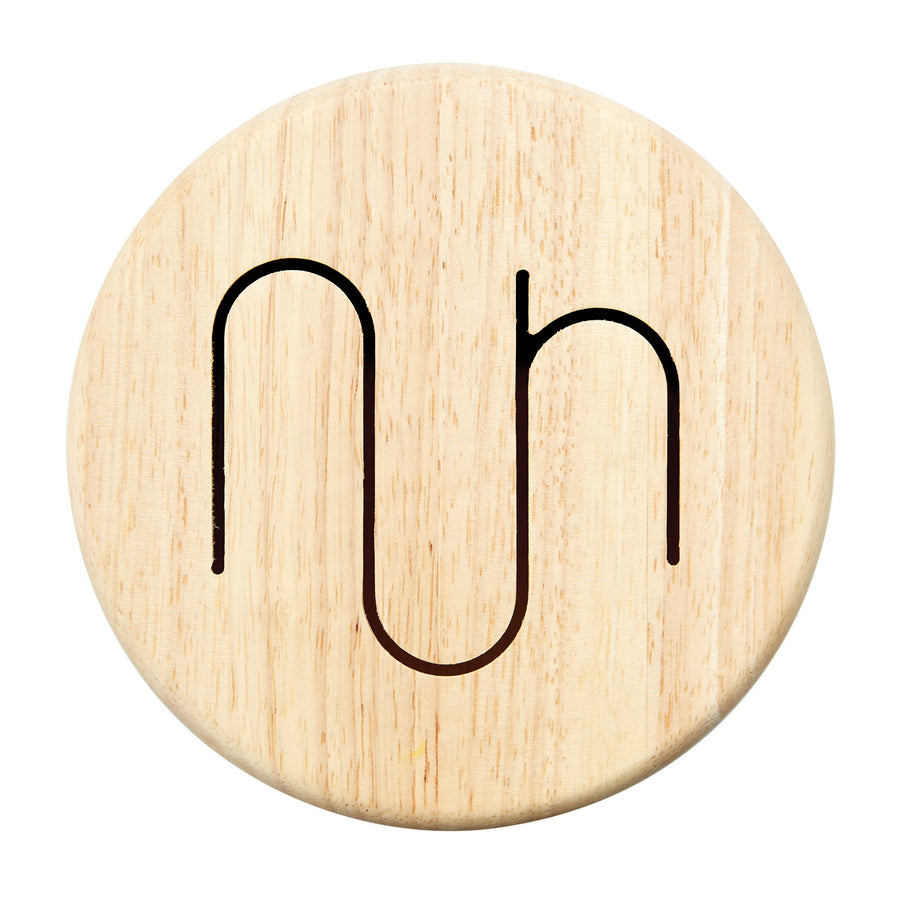 Close up of the curvy pattern on the top of the PlanToys children's solid wooden drum toy on a white background