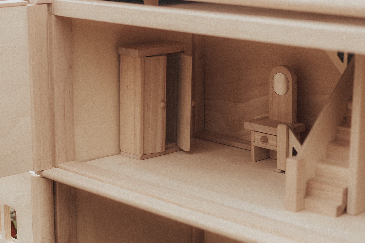 A close up of the furniture inside one of the rooms in the PlanToys Victorian Dolls House.  