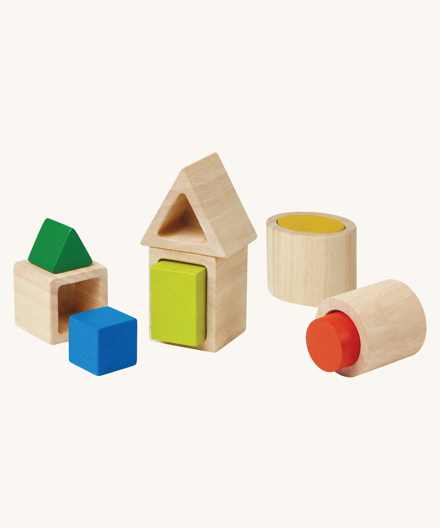 The PlanToys wooden Geo shapes Matching Blocks on a plain background. The blocks are shown out of their packaging. 
