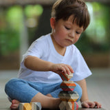 A child playing with the PlanToys Geo Stacking Rocks.