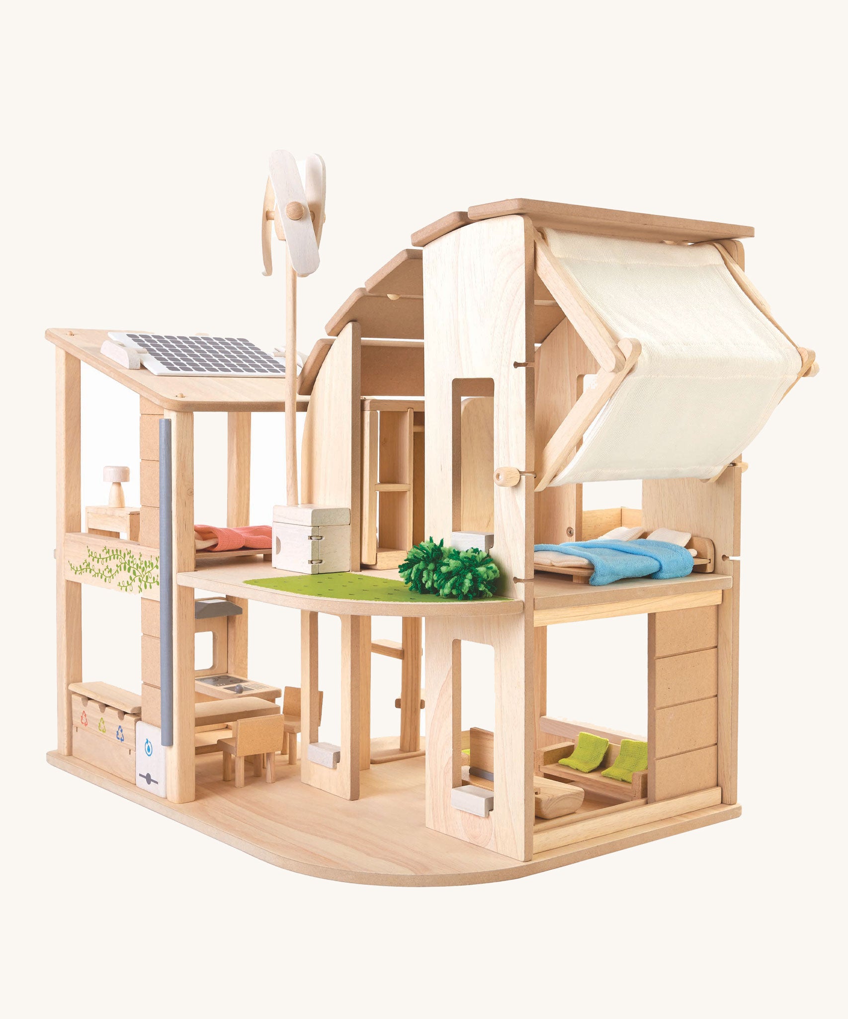 The Plan Toys Green Dolls' House and Furniture set on a plain background. 