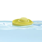 Close up of a PlanToys plastic-free natural rubber boat toy floating in some water