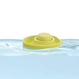 Close up of a PlanToys plastic-free natural rubber boat toy floating in some water