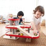 Children playing with the PlanToys PlanWorld Parking Garage.