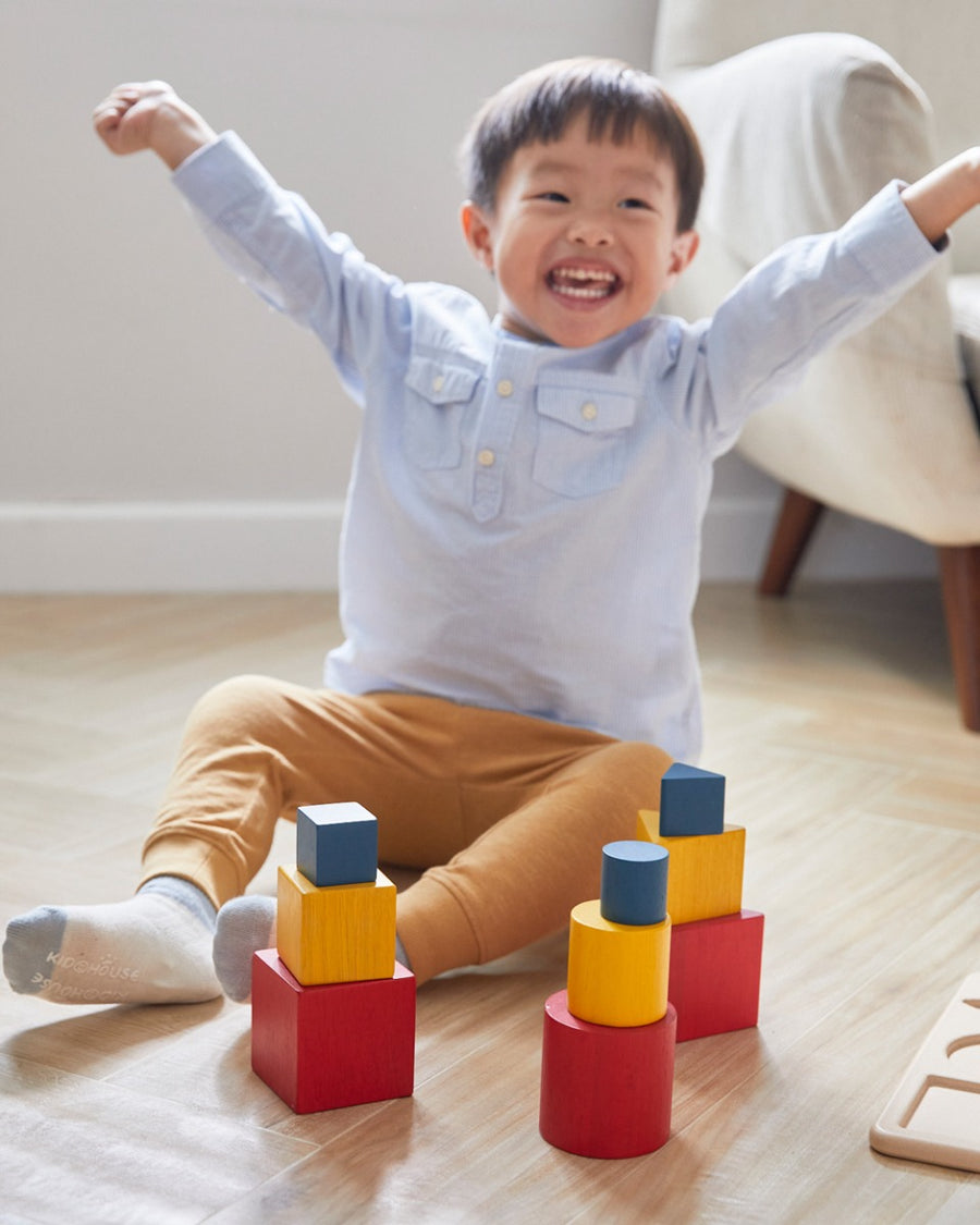 Young child sat on the floor cheering