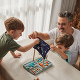 A family sitting around a table playing the PlanToys Guess My Planet Game. 
