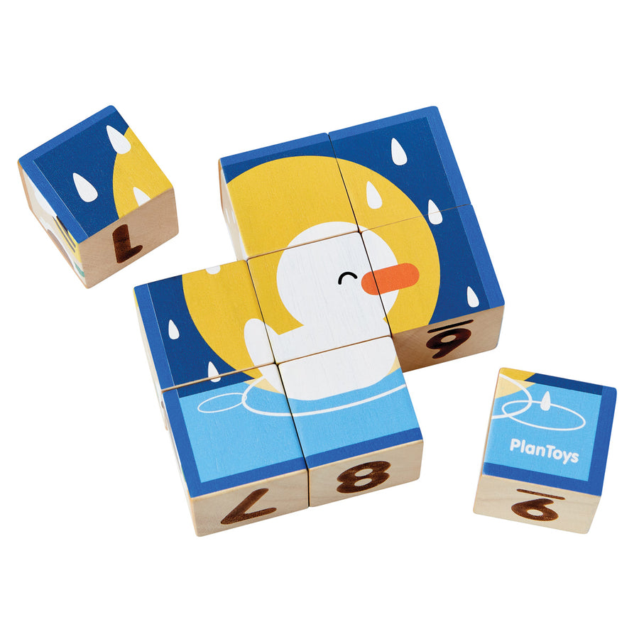 PlanToys kids wooden animal puzzle cubes laid out on a white background showing a picture of a duck on the front