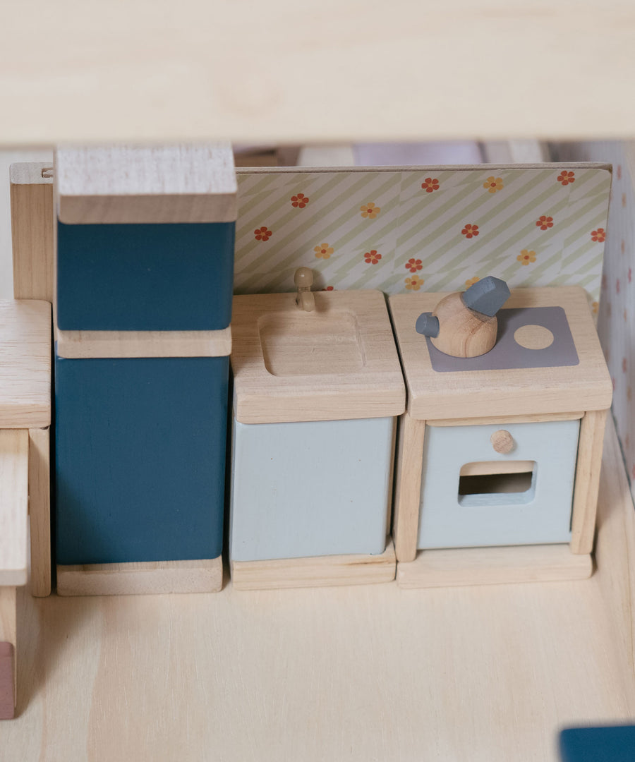 A close up of the PlanToys Kitchen Dolls House Furniture set
placed inside a dolls house.