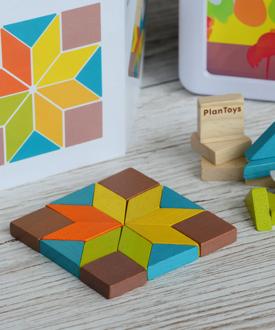 A shape created using pieces from the PlanToys mini mosaic set, the ideas leaflet can be seen in the background. 
