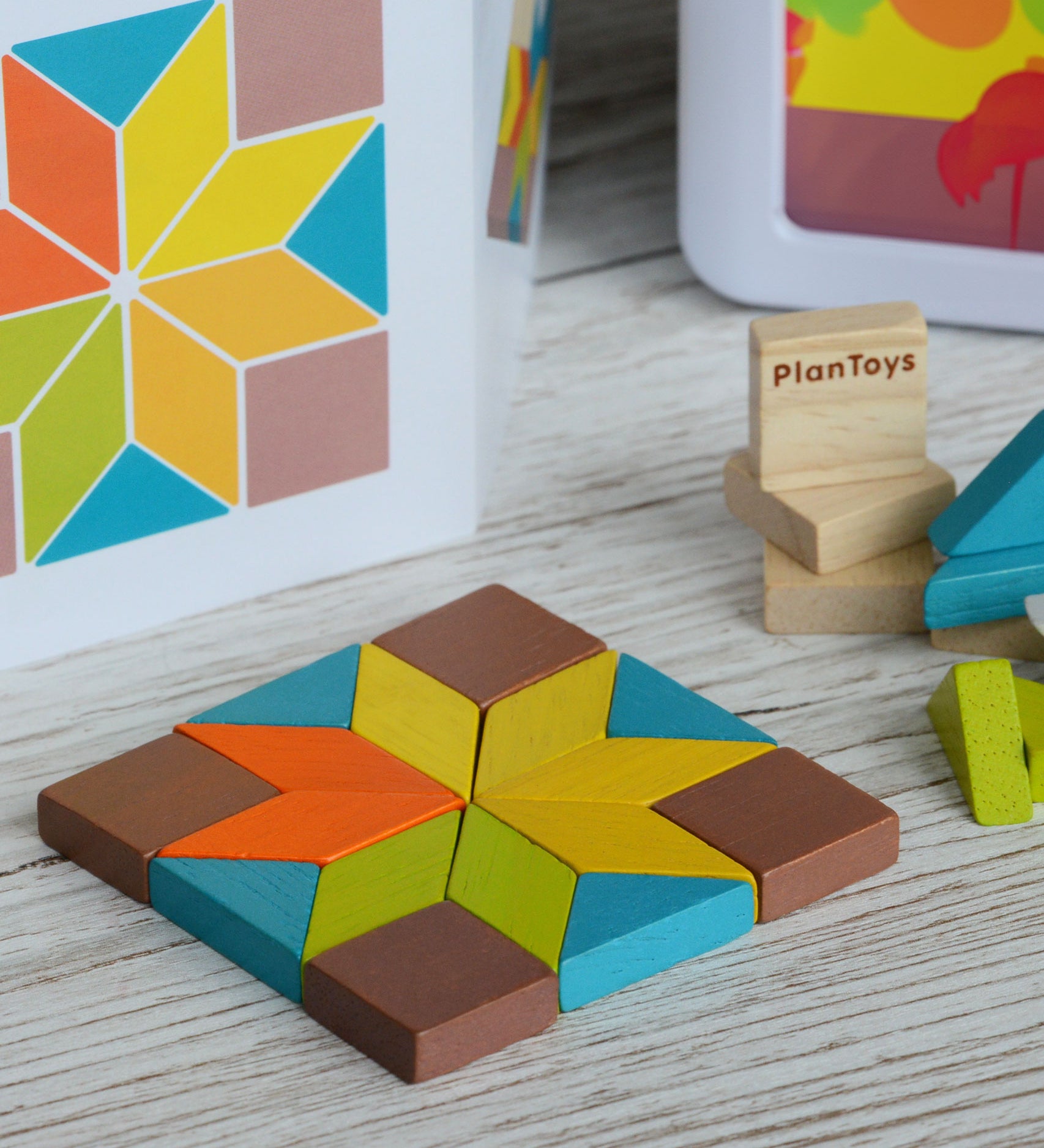 A shape created using pieces from the PlanToys mini mosaic set, the ideas leaflet can be seen in the background. 
