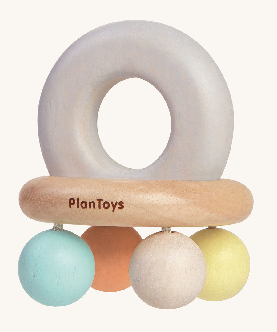 The PlanToys Pastel Bell Rattle on a plain background. 