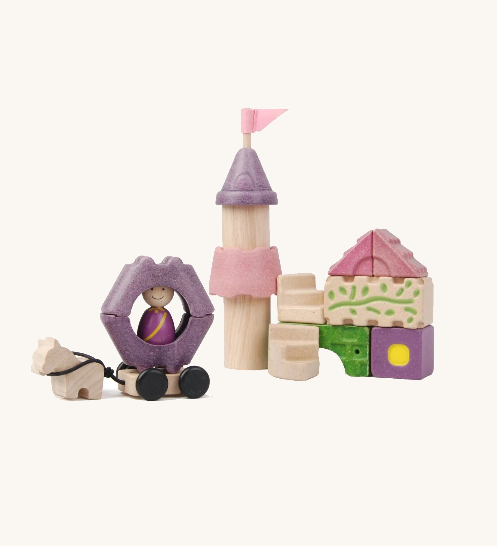 Pieces from the PlanToys Fairytale Castle Blocks on a plain background. 