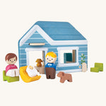 The PlanToys mini home set with both parent peg dolls, their baby in a little wooden crib, and their dog.