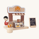 The PlanToys wooden bakery play set, with a mini Baker peg doll.