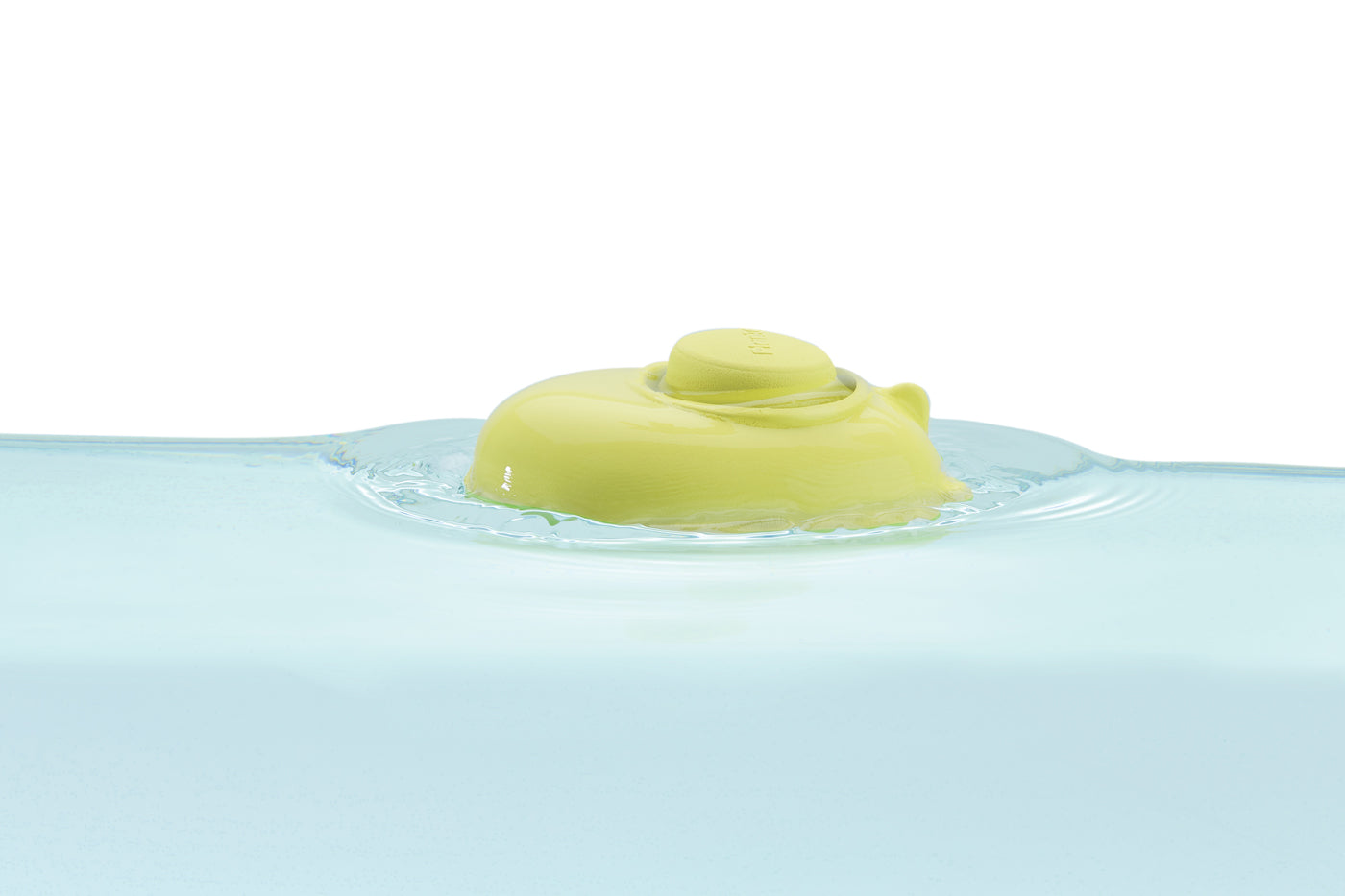 Close up of a PlanToys plastic-free natural rubber submarine toy floating in some water