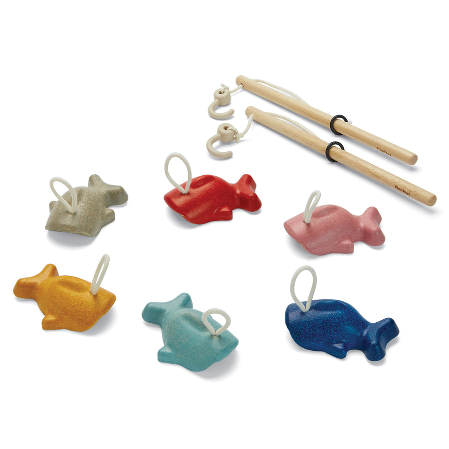 Pieces of the PlanToys plastic-free wooden fishing game laid out on a white background