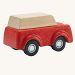 A view of teh back of a PlanToys Red SUV toy car on a plain background.