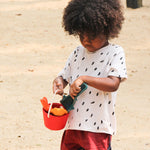 A child holding the PlanToys Sand Play Set.