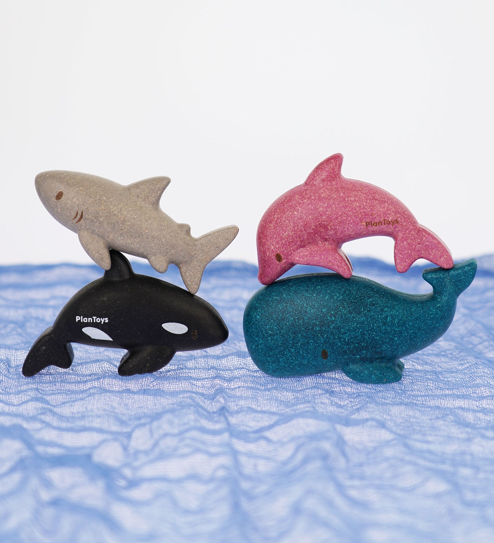 The PlanToys Sea Life animals Set pictured on a blue Ostheimer scarf. 