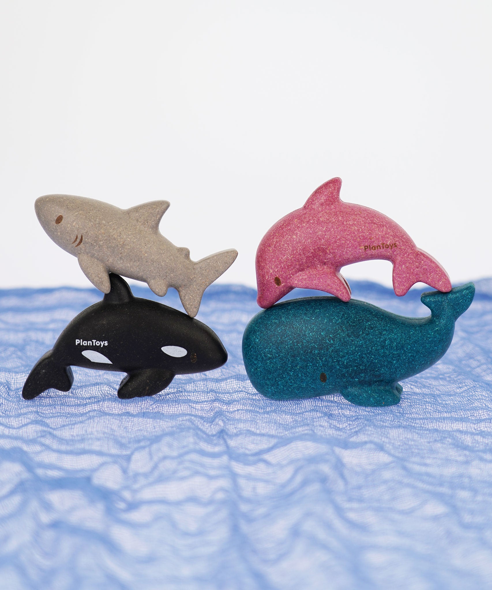 The PlanToys Sea Life animals Set pictured on a blue Ostheimer scarf. 