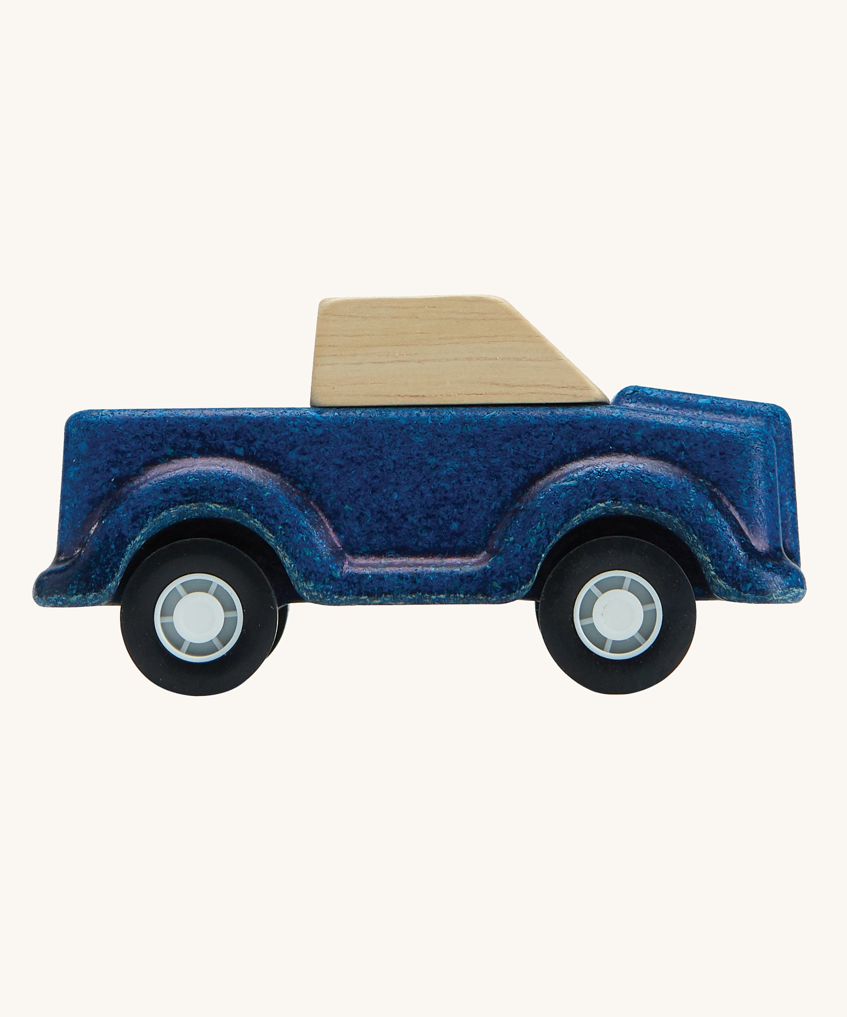 A side on view of the PlanToys Blue Truck on a plain background. 