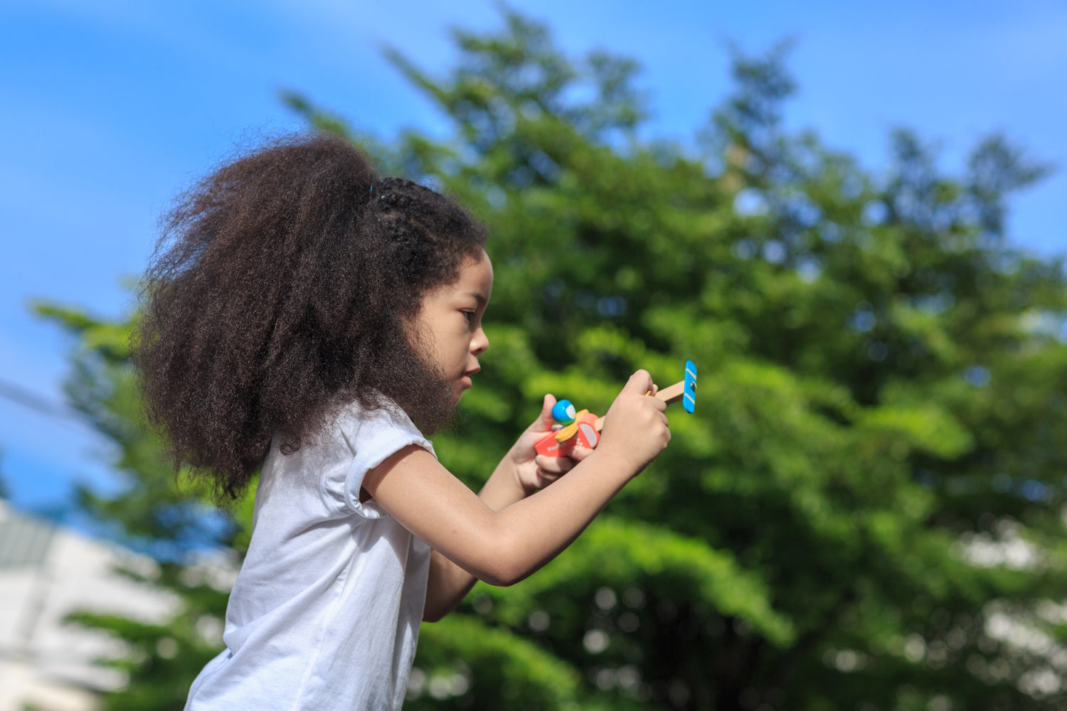 child playing with the PlanToys Spin N Fly Airplane