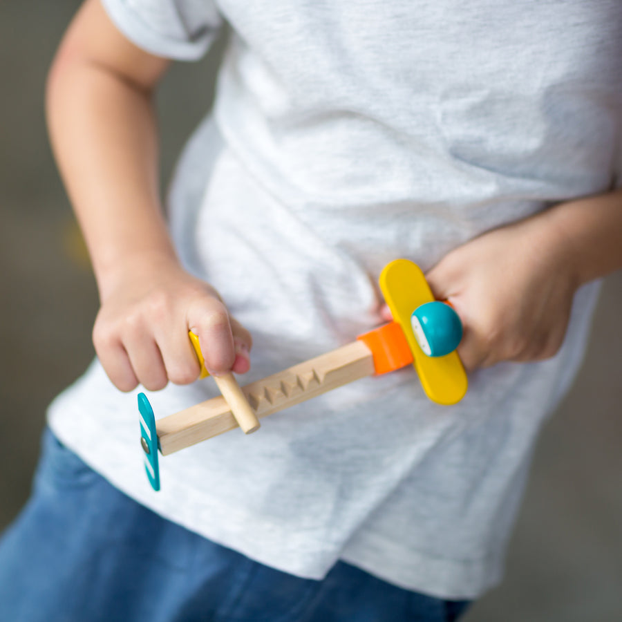 Close up of child playing with the PlanToys Spin N Fly Airplane